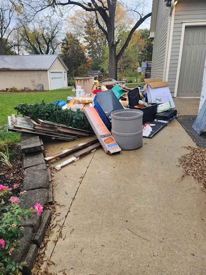 Dumpster being loaded with debris for Estate Cleanout Dumpster Rental in Hearne
